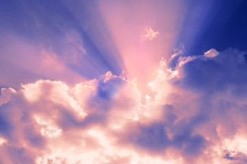 Fototapeta na wymiar Natural background sky. Beams of a rising sun shine through pink