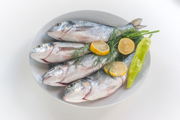 Fresh fishes with vegetables and lemon