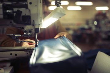 Worker in textile industry sewing