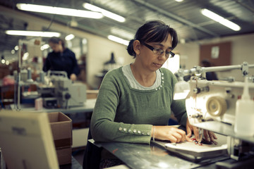 Worker in textile industry sewing