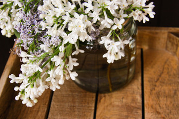 White lilac closeup on wooden tray 1