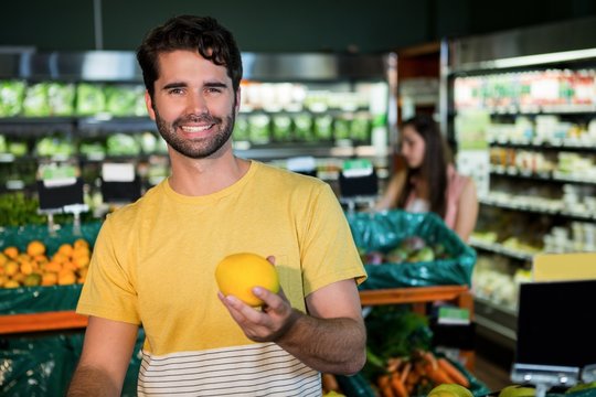 Man buying fruit in supermarket