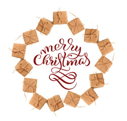 gift boxes of kraft paper isolated on a white background and text Merry Christmas. Calligraphy...