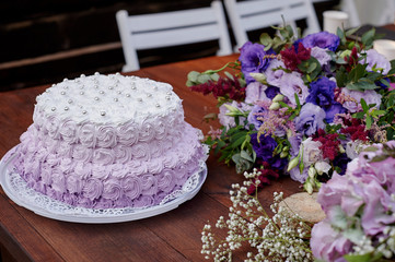 festive wedding cake and a bouquet of flowers on the table