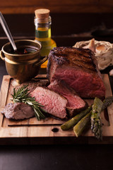Sliced medium rare grilled Beef steak  with rosemary and garlic