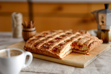 cake, a cup of cappuccino, coffee maker