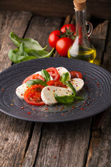 Caprese salad with mozzarella, fresh tomato and basil