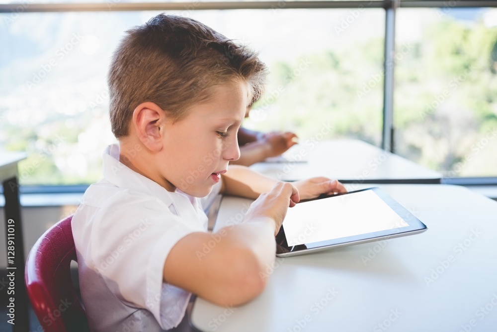 Poster schoolkid using digital tablet in classroom