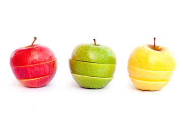 Cut red, green and yellow apples on white