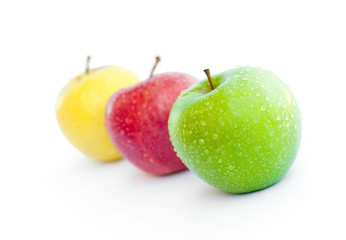 Red, green and yellow apples on white