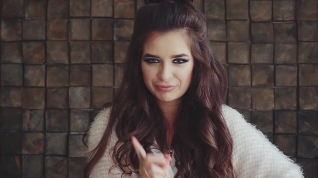 Beautiful arrogant woman making warning or rejection gesture with a finger slow motion