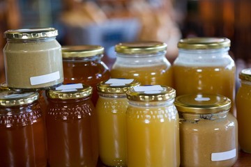 Jars of honey and nut butters on display shelf