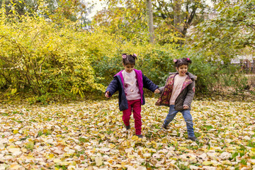 Little girls in autumn park