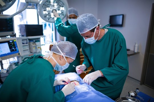 Surgeons performing operation in operation theater