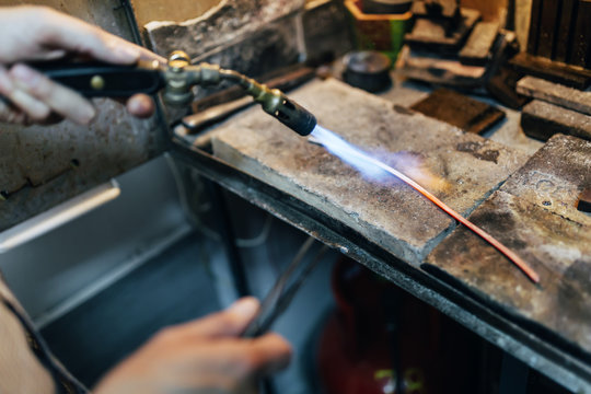 Jeweler processing metal
