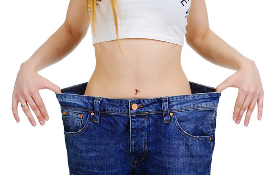 slim stomach girl in jeans large size on a white background. Weight Loss
