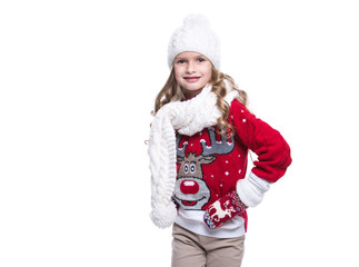 Cute smiling little girl with curly hairstyle wearing knitted sweater, scarf, hat and gloves isolated on white background. Winter clothes.