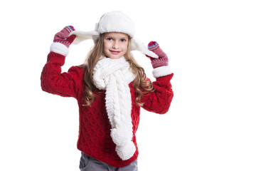 Cute smiling little girl with curly hairstyle wearing knitted sweater, scarf, hat and gloves isolated on white background. Winter clothes.