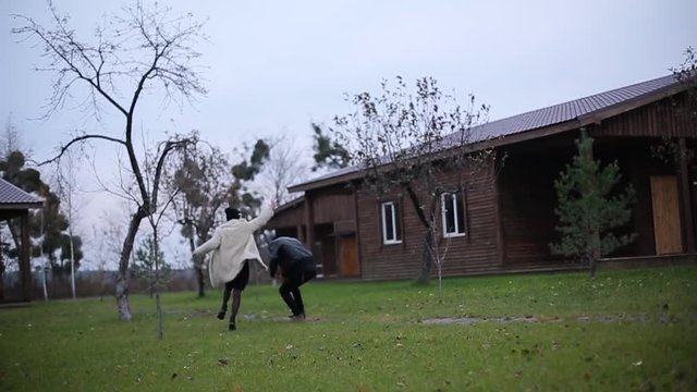 couple running on the autumn cottage.