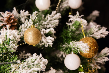 Baubles hanging on decorated Christmas tree