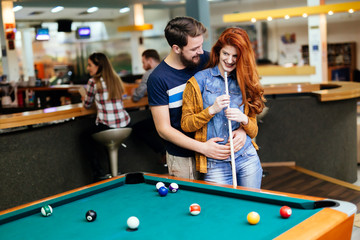 Couple spending time together by playing pool