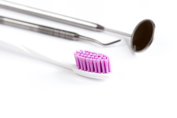 dental care toothbrush with dentist tools on white background