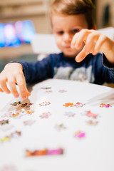 2 year old child solving jigsaw puzzle