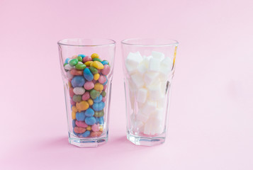 Glass candy on pink background. Sugar cocktail