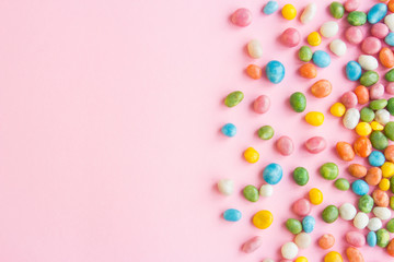 Fototapeta na wymiar Sweets scattered on pink background