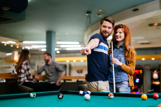 Couple spending time together by playing pool