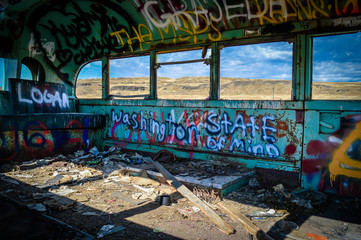 Inside of abandoned Washington bus with graffiti.