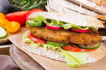sandwich with fried meat and vegetables