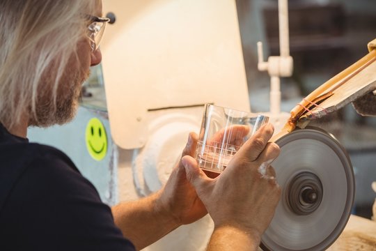 Glassblower polishing and grinding a glassware