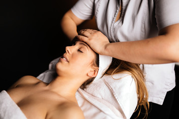 Massage therapist massaging woman