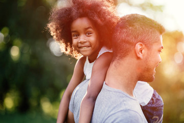 Father carrying daughter piggyback