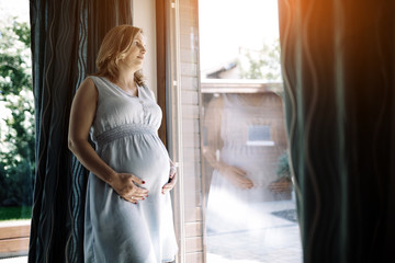 Pregnant woman holding her belly