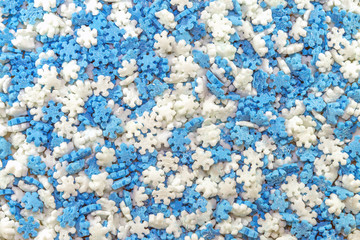 Tiny blue and white snowflake shaped baking sprinkles