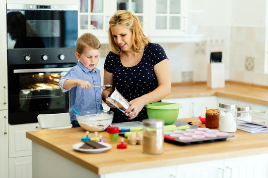 Mother and child preparing cookies