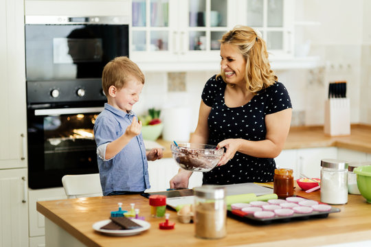 Mother And Child Preparing Cookies