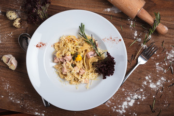 Concept: restaurant menus, healthy eating, homemade, gourmands, gluttony. Pasta Carbonara on weathered wooden background. Top-down view.