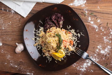 Concept: restaurant menus, healthy eating, homemade, gourmands, gluttony. Risotto with seafood on a weathered wooden background. Top-down view.