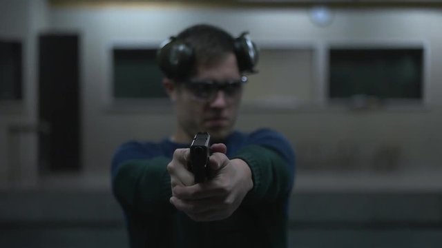 man holding a gun to the shooting range.