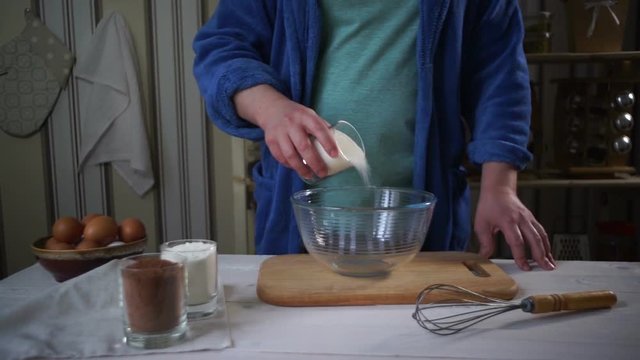 Chef cooking. Man add ingredients for chocolate cake into glass bowl. Cooking food. Man add flour into glass bowl. Homemade food. Baking ingredients. Cake ingredients