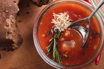Concept: restaurant menus, healthy eating, homemade, gourmands, gluttony. Gazpacho in a glass bowl on a messy wooden background. Top-down view.