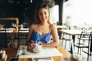 Woman drinking coffee in restaurant