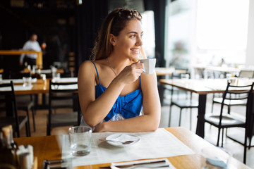 Stunning woman enjoying her coffee