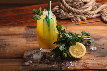 Concept: restaurant menus, healthy eating, homemade, gourmands, gluttony. Handmade lemonade with ingredients on messy vintage weathered wooden background.