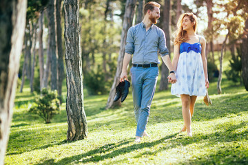 Naklejka na ściany i meble Romantic couple walking forest