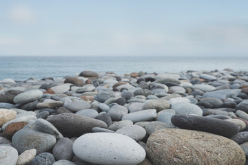 Fototapeta na wymiar pebble stone beach ocean background