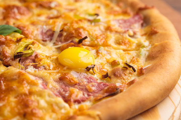 Concept: restaurant menus, healthy eating, homemade, gourmands, gluttony. Pizza carbonara on a wooden vintage table with ingredients. Detail